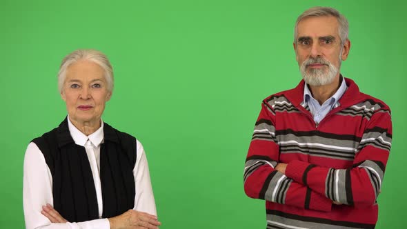 An Elderly Couple Smiles at the Camera and at Each Other - Green Screen Studio alt