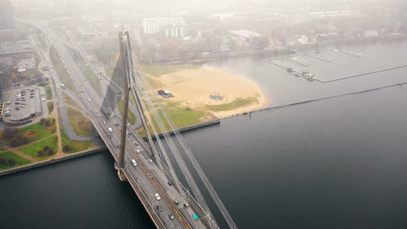 Amazing Aerial Cityscape View, Traffic on Cable Bridge Over Daugava in Riga Old Town Under Thick Fog alt