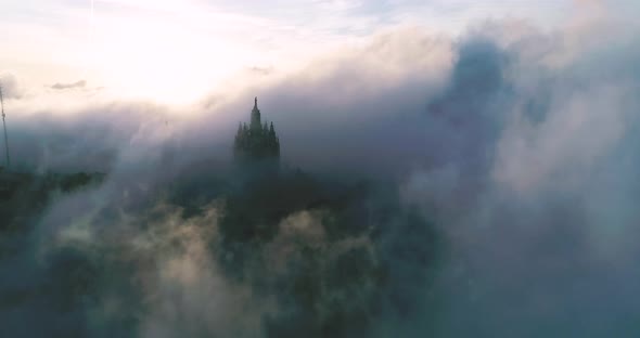 Steady Drone Footage in the Morning with Thick Fog Tibidabo in the Background