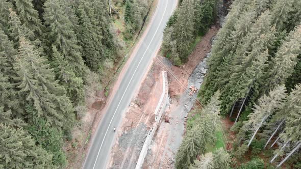 Epic mountain landscape. Cyclist cycling on bicycle on mountain road. alt
