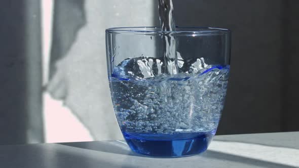 Water Is Poured Into A Glass Beaker