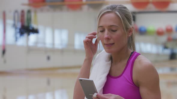 Woman at gym listening to music