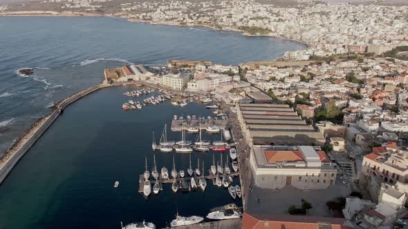 Harbor with boats and cityscape of Chania city, aerial drone view alt