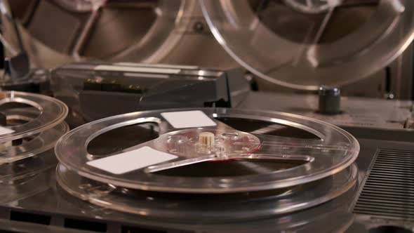 Two Reel to Reel tape recorders playing music together with four tapes alt