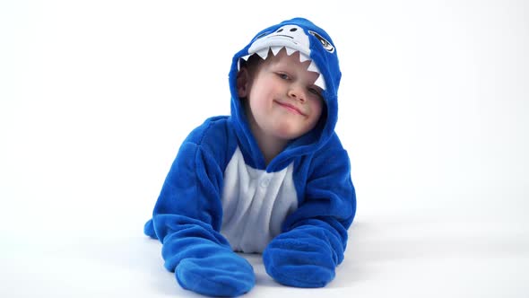 Cheerful Little Boy Posing on a White Background in Pajamas Kigurumi