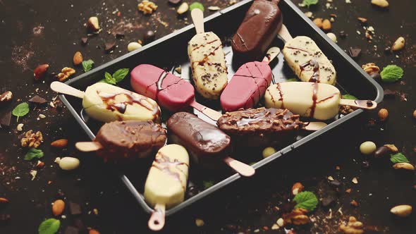 Assortment of Various Popsicle Ice Cream, White and Dark Chocolate, with Almonds, Rusty Background alt
