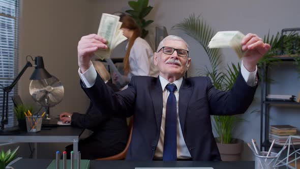 Cheerful Senior Business Company Manager Celebrating Business Success Dancing with Money Dollar Cash alt