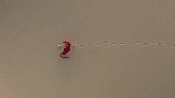  Slow Motion Aerial View of a Woman Walking By Sand Dunes at the Desert Nature, USA alt