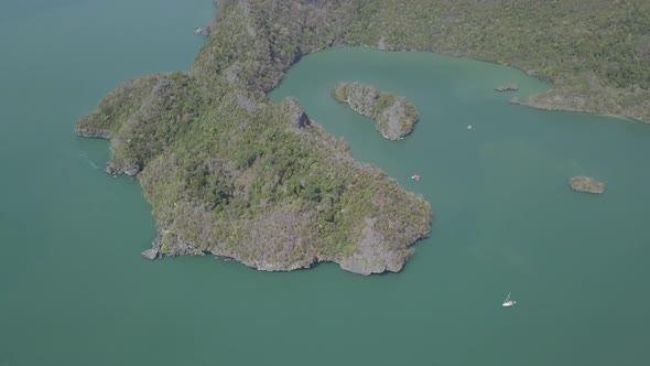 Aerial view of island in sea. Boat floating near. Park Kilim Geforest, Langkawi, Malaysia. Nature