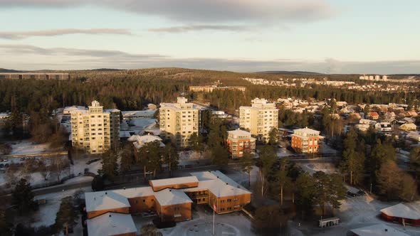 White Rooftops And Snowy Driveways In The Quiet City Of Sundsvall In Sweden -aerial shot alt