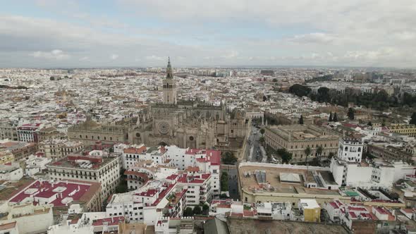 Aerial view Majestic Seville Cathedral in city centre, Buildings Sprawling, Andalusia