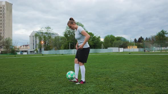 Portrait of Woman Football Player in Full Growth in the Evening Park alt