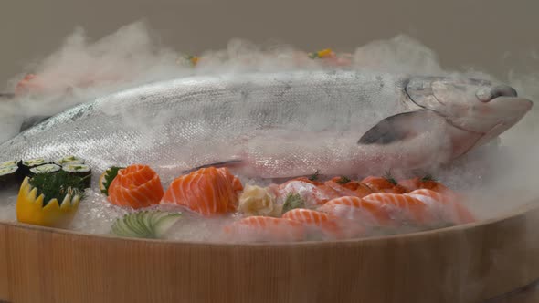 Variety of fresh sushi and whole Salmon on ice. alt