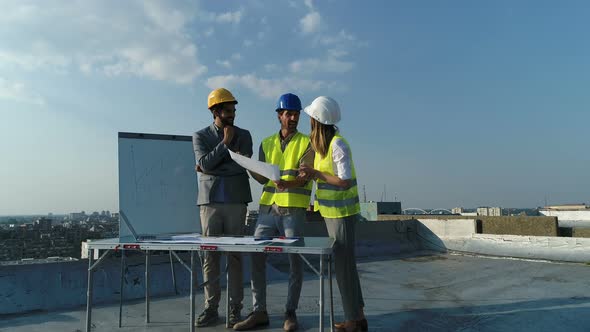 Group of Engineers Architects Business Partners at Construction Site Working Together