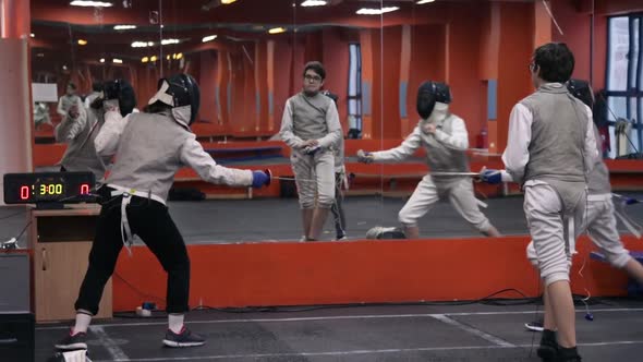 Kids practicing fencing at a fencing school