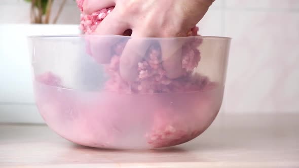 Man Mixes Minced Meat in Bowl His Hands