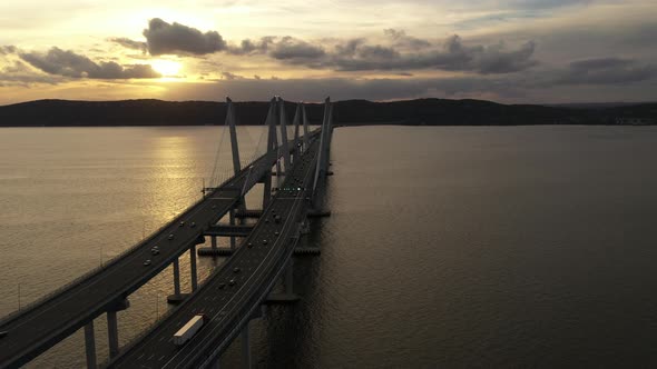 An aerial shot over the Mario M. Cuomo Bridge from the north side. The camera dolly in over the brid alt