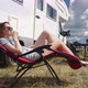 Camper Rv Woman Sitting On Folding Chair and Drinking Juice - VideoHive Item for Sale