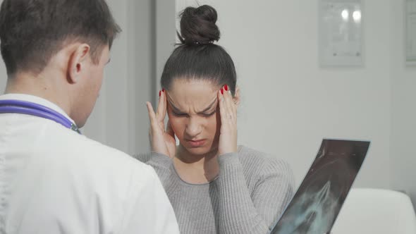 Young Woman with Terrible Migraine Visiting Doctor alt
