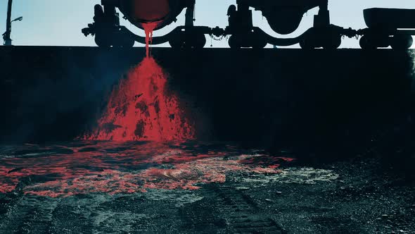 Liquid Copper is Flowing Out of the Steel Ladle Located Outdoors alt