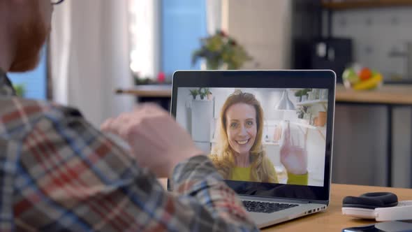 Cropped Shot of Young Man Having Video Call on Laptop and Waving Hand at Home alt