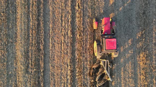 Farmer in Tractor at Work Preparing Plowing Land with Agricultural Field alt