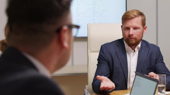 Businesspeople Discussing Work during Meeting alt