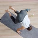 Top View Slot Motion of Sportsman Doing Handstand on Yoga Mat Enjoying Practice in Studio - VideoHive Item for Sale
