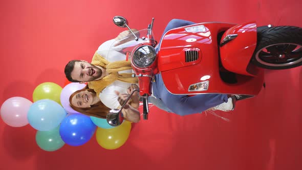 Fun Couple on a Motorcycle, Scooter Bringing a Load-bearing Bunch of Balloons Holiday Decoration alt