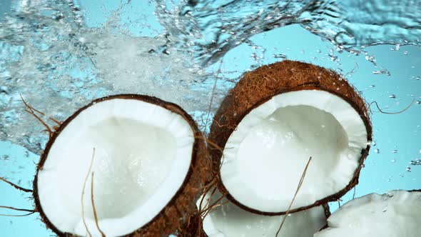 Super Slow Motion Shot of Flying Fresh Coconuts and Water Side Splash at 1000Fps. alt