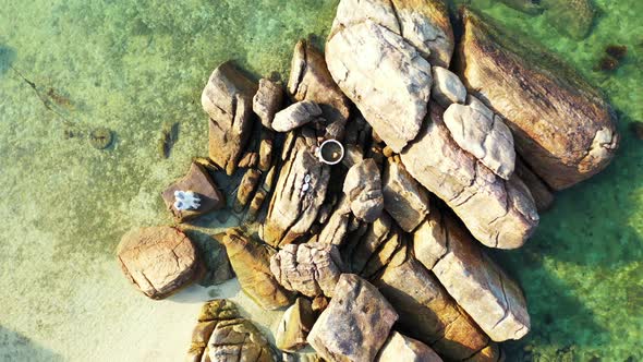Barbuda, aerial. Boulders in the calm emerald sea water. high angle alt