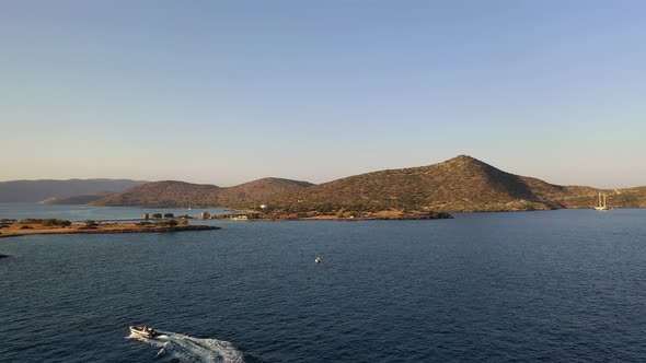 Aerial View of a Motor Boat in a Deep Blue Colored Sea. Kolokitha Island, Crete, Greece