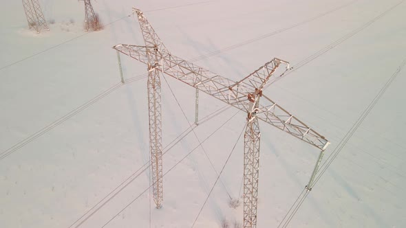 ABOVE VIEW Power Pylons in a Field in Winter alt