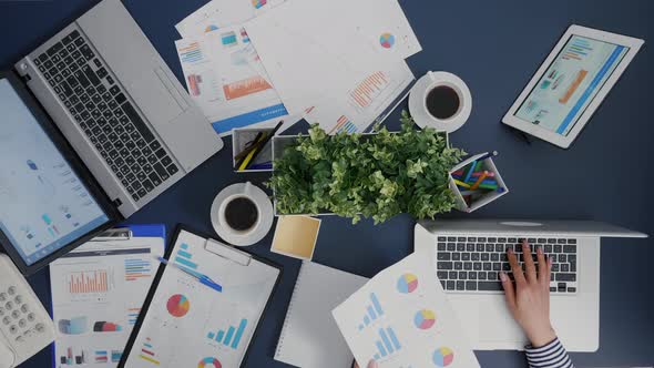 Top View of Manager Woman Analyzing Financial Paperwork Strategy Typing Expertise on Laptop alt