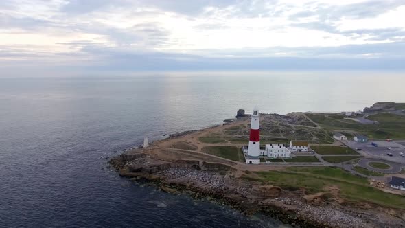 Lighthouse on the cliff aerial view at dusk in England