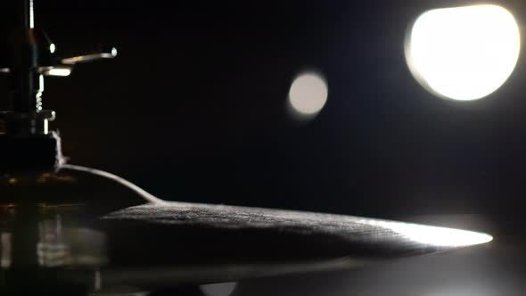 Hands of musician drummer holding drum sticks hitting on hi-hat cymbal alt
