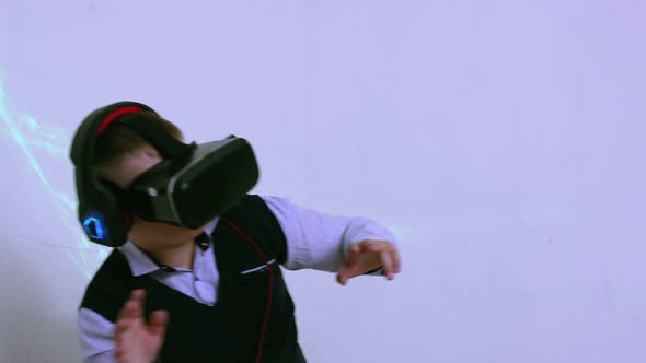 A Boy in an Augmented Reality Helmet Plays and Dodges Virtual Threats alt