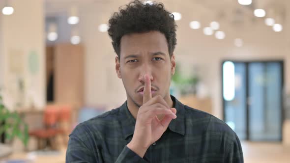 African American Man Showing Quiet Sign Finger on Lips alt
