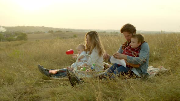 Parents Playing with Kids During Picnic in Field