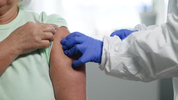A Nurse or Doctor Wearing a Medical Glove Injects a Coronavirus Vaccine or Other Vaccine Into the