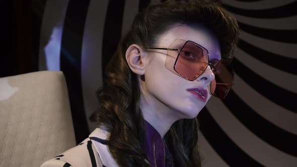 Psychiatrist Doctor Leads a Patient Girl in Stylish Striped Suit Sits Chair Against Hypnotic Spiral alt