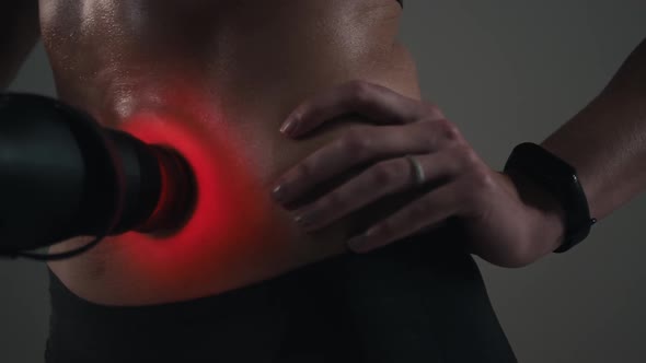 Girl Uses a Massager on Her Stomach Close-up