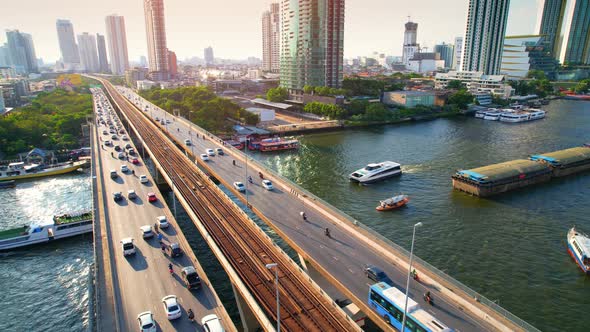 4K : Drones fly over the Chao Phraya River. Aerial view over bts skytrain alt