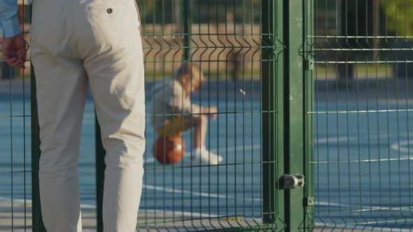Child waiting for father on the court alt
