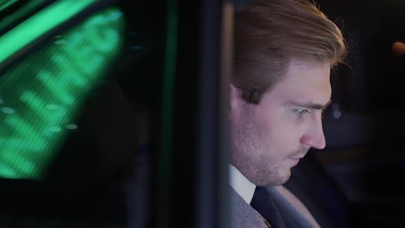 Businessman Sitting in a Moving Car and Drinks Coffee Man Top Manager in a Suit is Sitting in the alt