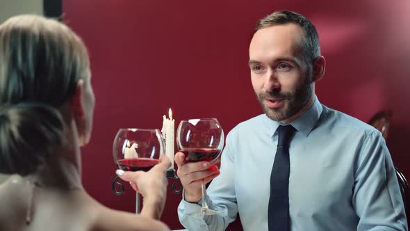Happy Male Toasting Clink Glasses of Wine with Sexy Woman alt