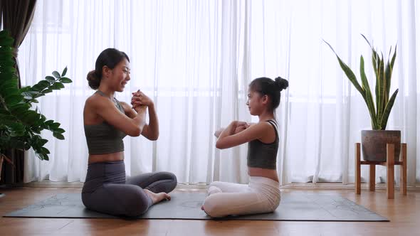 Healthy Little girl and mother doing soft yoga at hand position at home