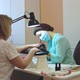 A manicurist in a protective mask doing a manicure to a client. - VideoHive Item for Sale