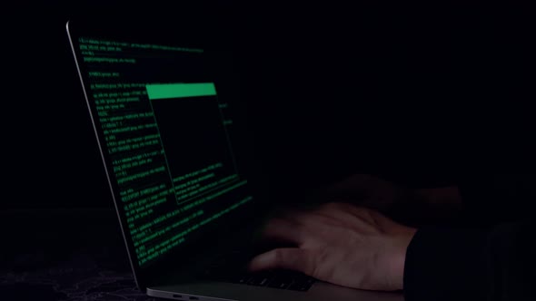 Hands Hacker Using Laptop Computer Hacking In The Dark Room alt