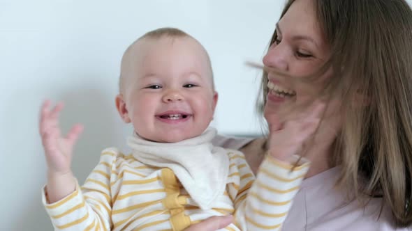 Little Infant Child Laughing Having Fun and Looking in Camera alt